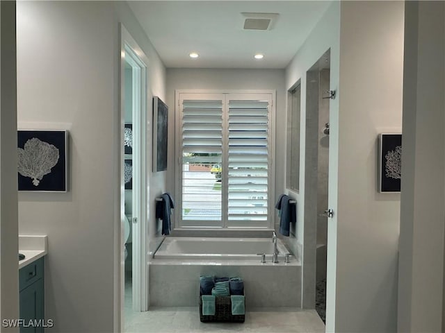 bathroom with vanity and independent shower and bath