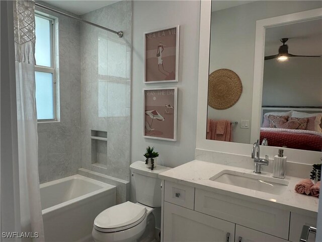 full bathroom with toilet, vanity, ceiling fan, and shower / tub combo with curtain