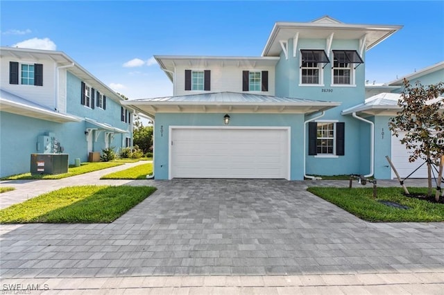 view of front of home with a garage and cooling unit