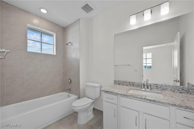 full bathroom featuring toilet, tiled shower / bath combo, tile patterned floors, and vanity