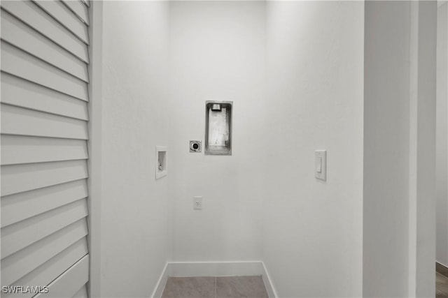 washroom featuring electric dryer hookup, hookup for a washing machine, and light tile patterned floors