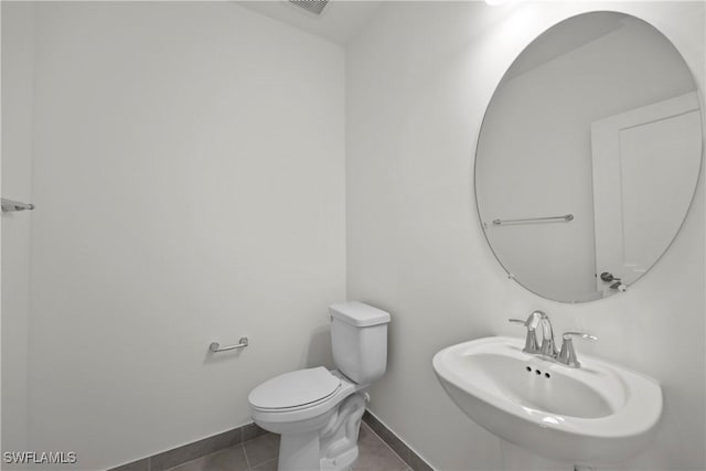 bathroom with sink, tile patterned flooring, and toilet