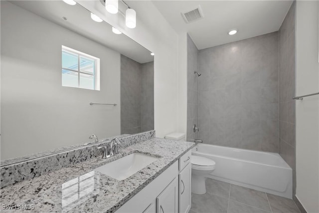 full bathroom featuring tile patterned floors, toilet, vanity, and tiled shower / bath