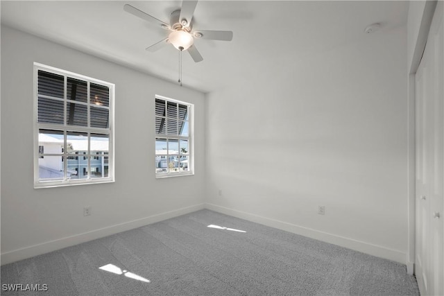 unfurnished room featuring carpet floors and ceiling fan