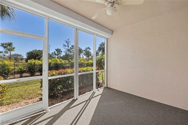 unfurnished sunroom with ceiling fan