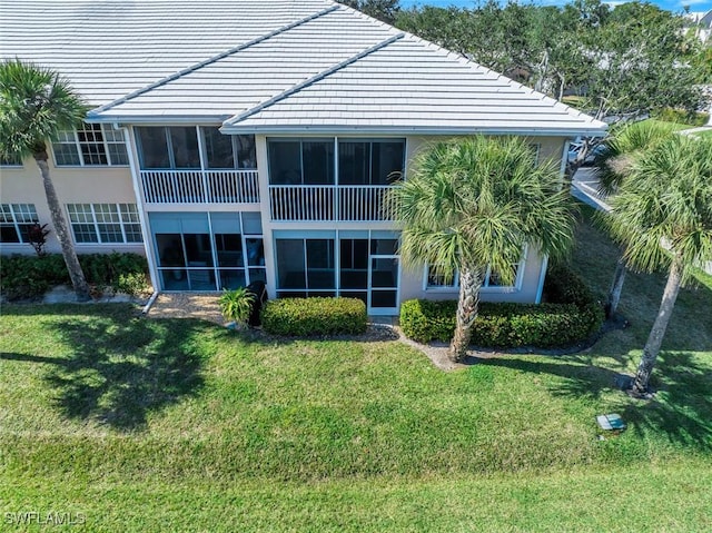 rear view of property with a lawn