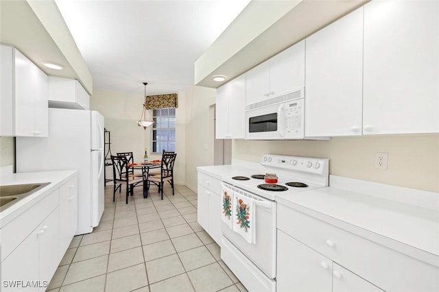 kitchen featuring light tile patterned flooring, white cabinetry, sink, hanging light fixtures, and white appliances