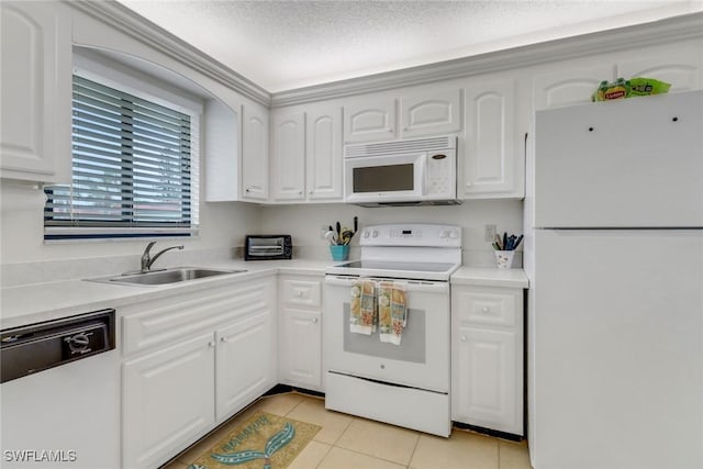 kitchen featuring light tile patterned floors, white cabinetry, white appliances, a textured ceiling, and sink