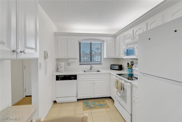 kitchen featuring white appliances, white cabinets, a textured ceiling, sink, and light tile patterned floors