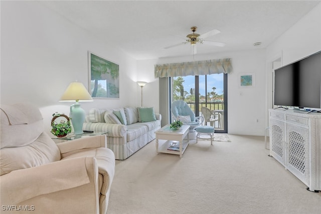 carpeted living room with ceiling fan