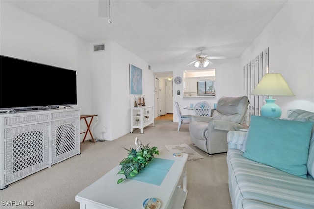 carpeted living room featuring ceiling fan