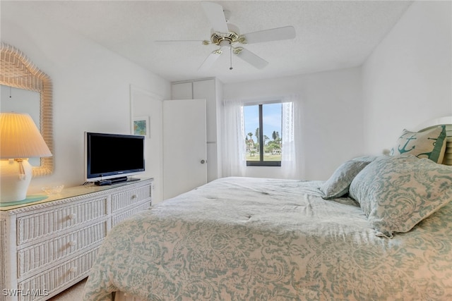 bedroom with a textured ceiling and ceiling fan