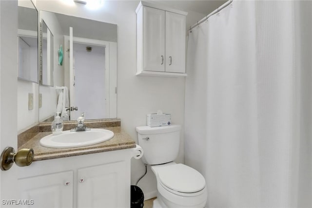 bathroom featuring toilet and vanity