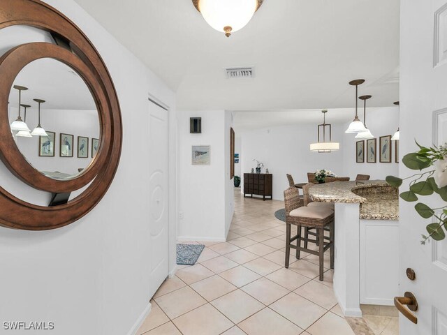 hall with light tile patterned floors