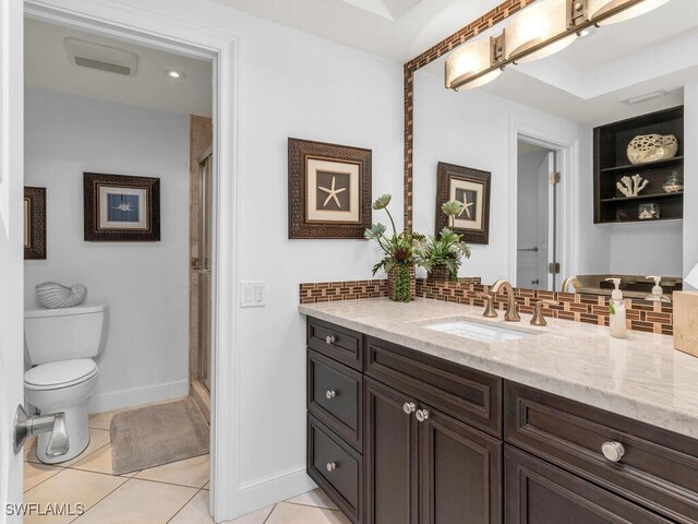 bathroom with toilet, decorative backsplash, tile patterned flooring, an enclosed shower, and vanity