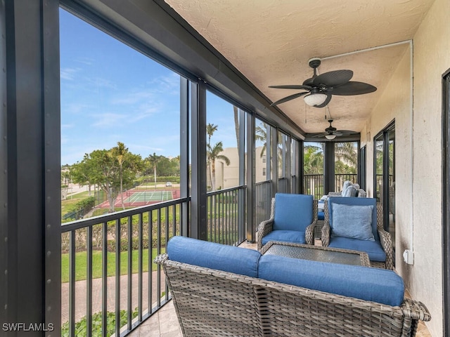 sunroom / solarium featuring ceiling fan