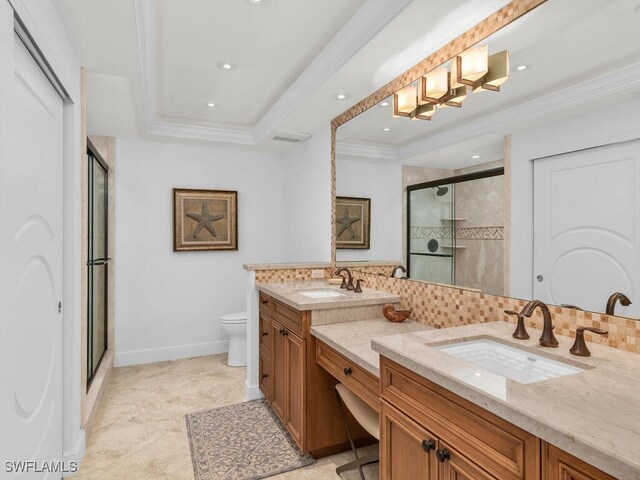 bathroom featuring tasteful backsplash, a tray ceiling, an enclosed shower, ornamental molding, and vanity