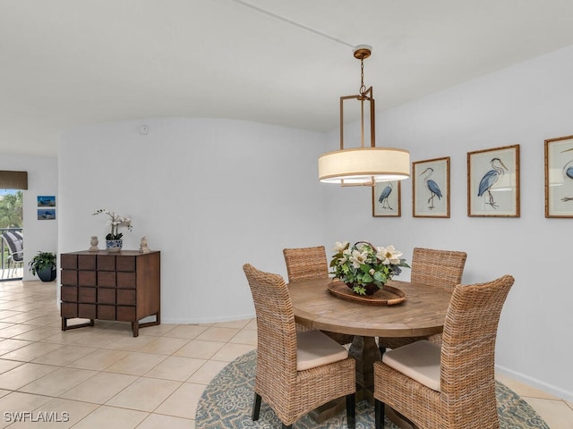 dining room with vaulted ceiling and light tile patterned flooring