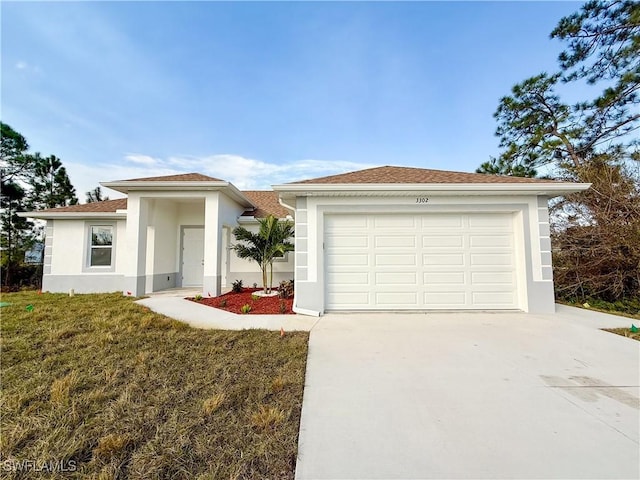 single story home featuring a garage and a front yard