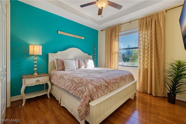 bedroom with hardwood / wood-style floors and ceiling fan