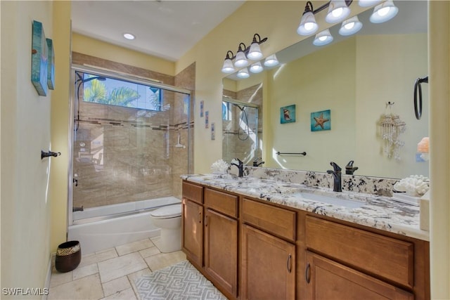 full bathroom with vanity, shower / bath combination with glass door, and toilet