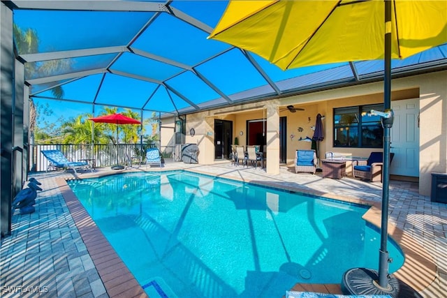 view of pool featuring a patio, a lanai, and ceiling fan