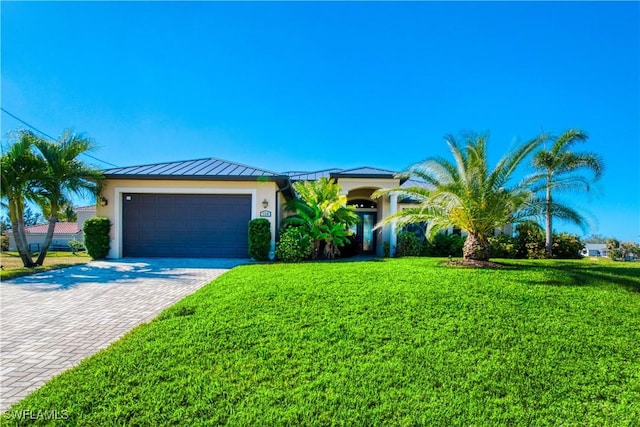 view of front of home featuring a garage and a front yard