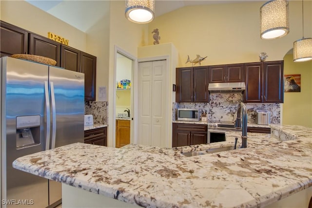 kitchen featuring pendant lighting, appliances with stainless steel finishes, sink, and decorative backsplash