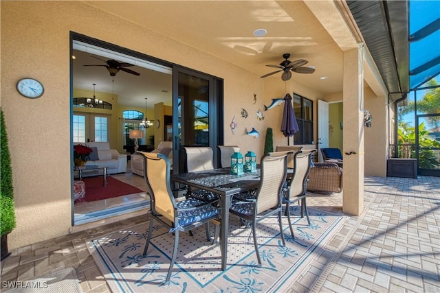 view of patio / terrace with ceiling fan and a lanai