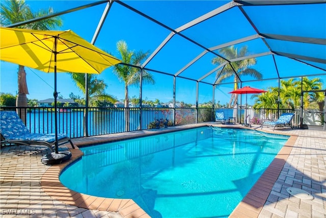 view of swimming pool with glass enclosure and a patio area