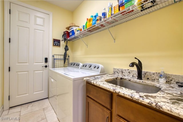 laundry area with cabinets, sink, and washing machine and dryer