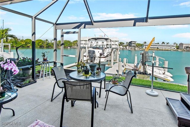 view of patio featuring glass enclosure, a water view, and a boat dock