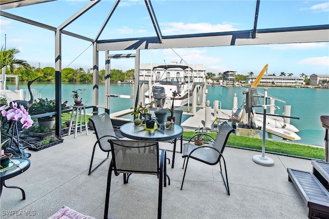 view of patio / terrace featuring a lanai, boat lift, a water view, and a boat dock