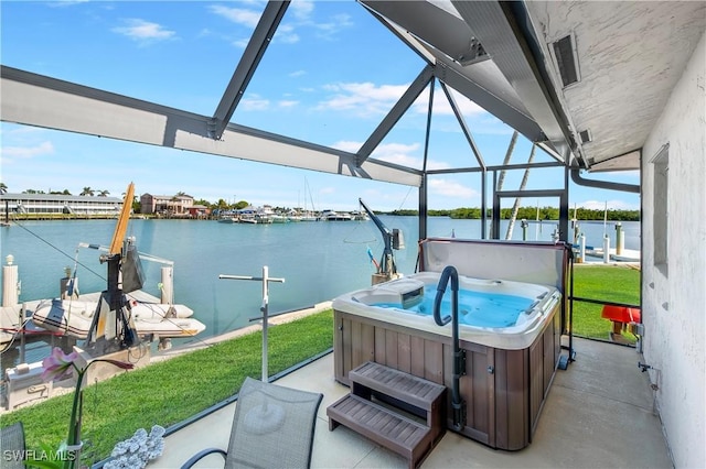 view of patio with glass enclosure, a water view, a boat dock, and a hot tub