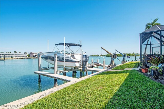 view of dock with a yard and a water view