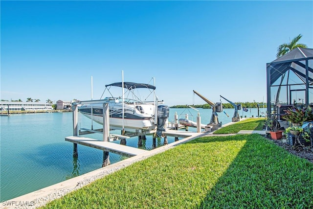 view of dock featuring a lanai, boat lift, a lawn, and a water view