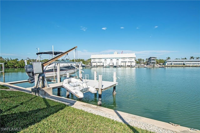 dock area featuring a yard, a water view, and boat lift