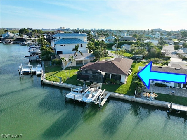 birds eye view of property featuring a water view and a residential view