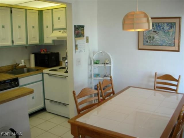 kitchen with black appliances, decorative light fixtures, sink, tile countertops, and light tile patterned floors