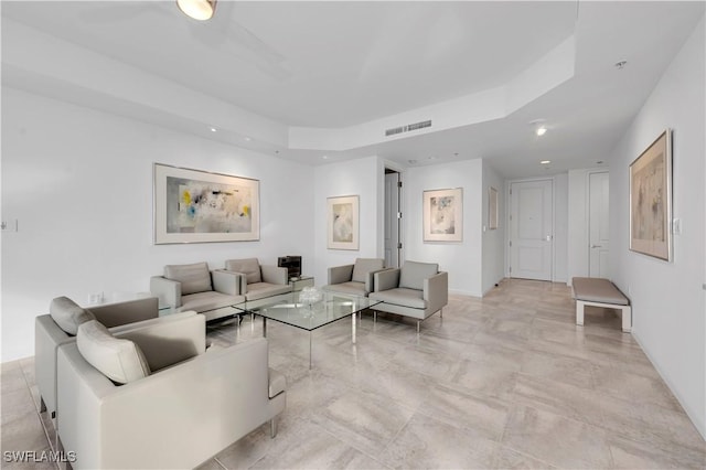 living room featuring a raised ceiling