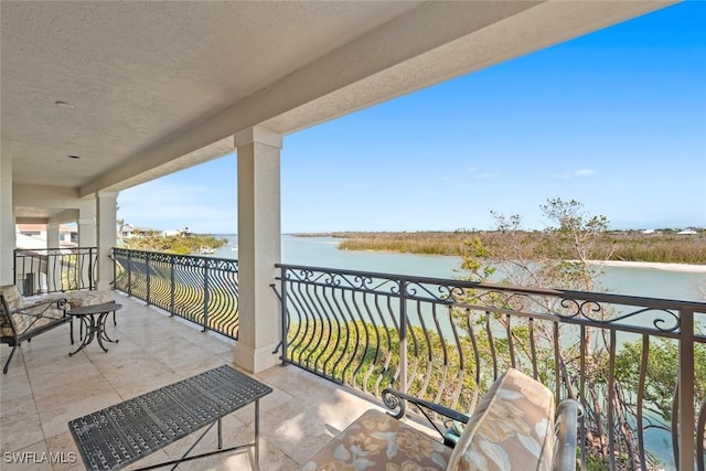 balcony featuring a water view