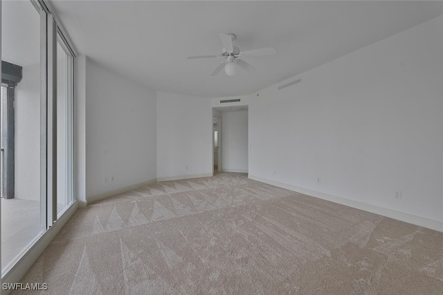 unfurnished bedroom with light colored carpet and ceiling fan