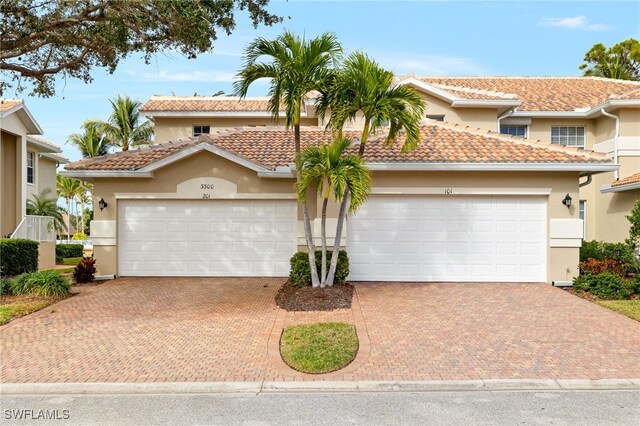 mediterranean / spanish-style home with a garage