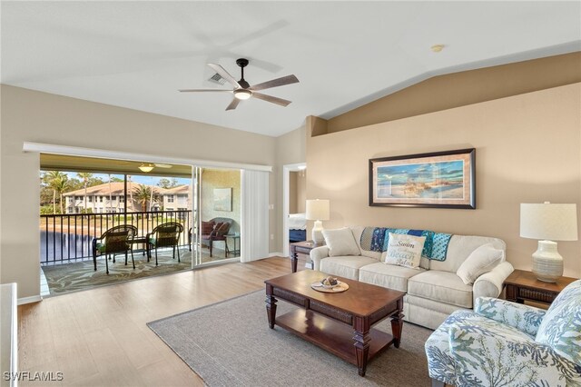 living room with light wood-type flooring, vaulted ceiling, and ceiling fan