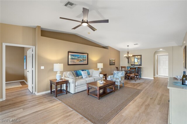 living room featuring light wood-type flooring, ceiling fan with notable chandelier, and vaulted ceiling