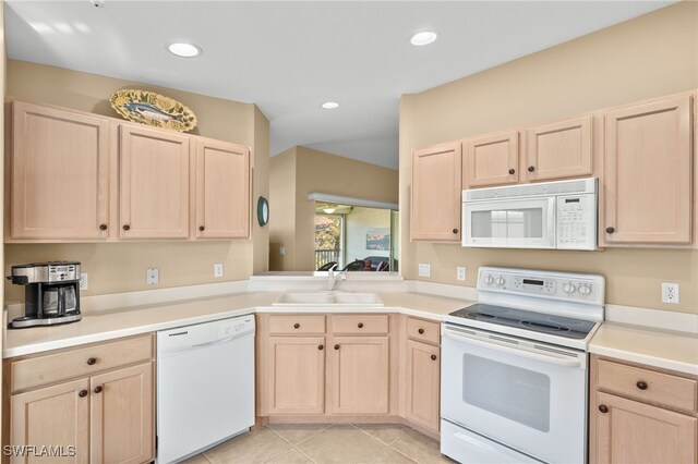 kitchen featuring light brown cabinetry, sink, white appliances, and light tile patterned floors