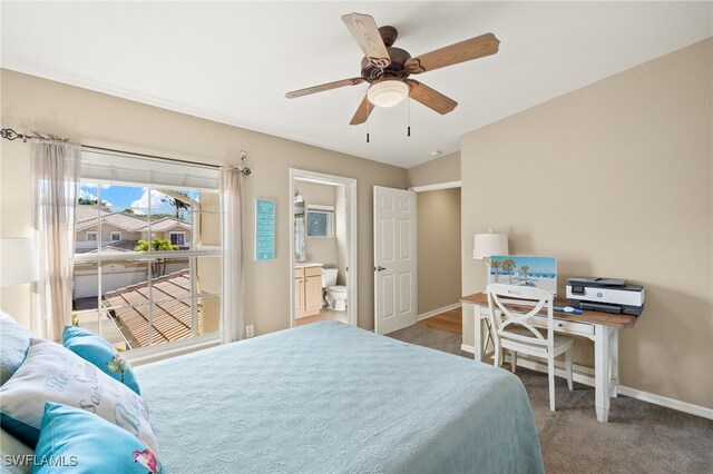 bedroom featuring ceiling fan, ensuite bathroom, dark colored carpet, and lofted ceiling