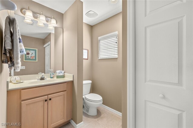 bathroom with vanity, toilet, and tile patterned floors