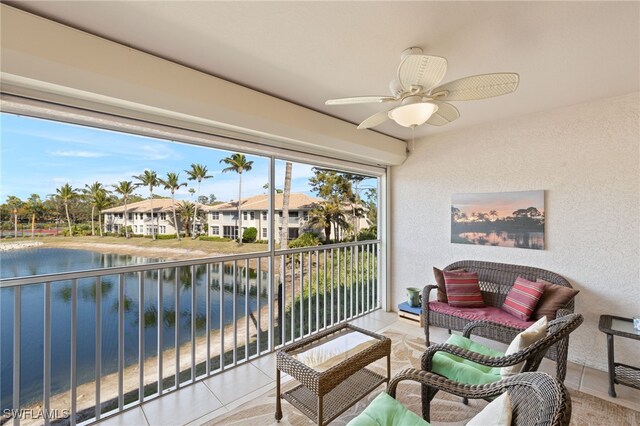 balcony with a water view and ceiling fan