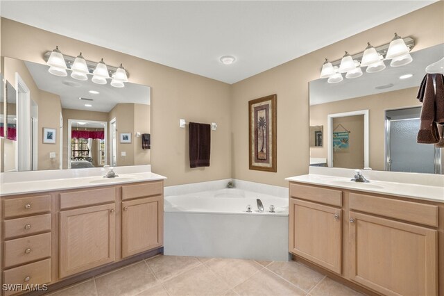 bathroom featuring a bath, tile patterned floors, and vanity